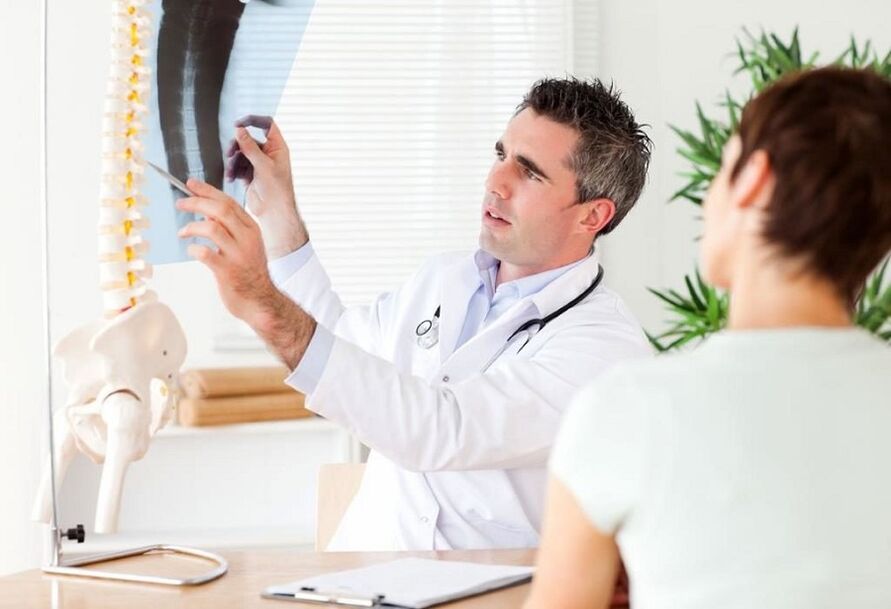 Doctor examines X-ray to diagnose thoracic osteochondrosis